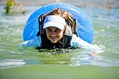 A woman floats and swims on an inner tube, Bear Lake.