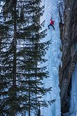 Two male climbers climbing ice falls in Ceresole Reale ice park, Piemonte, Italy