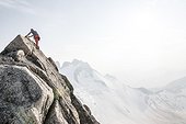 Mountain climber climbing up Bugaboo Spire, Bugaboo Mountains, British Columbia, Canada