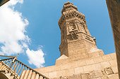 Low angle view of minaret of Zuwayla Door against cloudscape, Cairo, Egypt