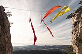 Female aerial silk gymnasts performing between two cliffs 30 meters above ground, Lower Austria, Austria