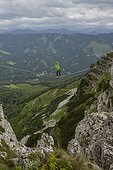 Man highlining on tightrope in Lower Alps, Lower Austria, Austria