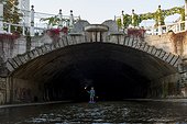 Man paddleboarding in underground river, Vienna, Austria