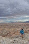 Adult woman hiking in badlands section of Anza Borrego State Park, California, USA