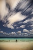 Lone man standing at beach and looking at ocean, Marley Beach, Bermuda