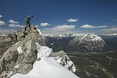 Mountain climber at summit of Mount Rundle, Banff National Park, Alberta, Canada