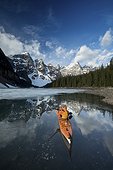 Man kayaking in Moraine Lake in winter, Banff National Park, Alberta, Canada