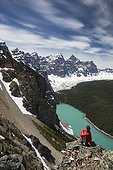 Woman looking at view of Moraine Lake from Tower of Babel, Banff National Park, Alberta, Canada