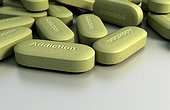 An image of numerous pills with the word 'Addiction' embossed on them.