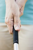 Woman's hands holding golf club