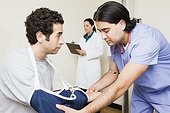 Patient having arm examined