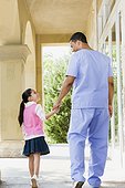 Nurse walking with young girl