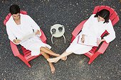 Couple outdoors relaxing side by side