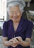 Elderly woman using MP3 player
