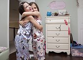 girls hugging in bedroom