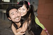 Japanese boyfriend carrying girlfriend on back