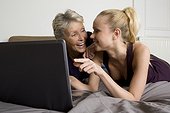 Mother with adult daughter using computer
