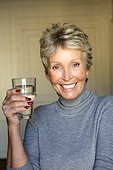 Mature woman with glass of water