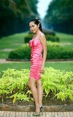young woman with pink dress in park