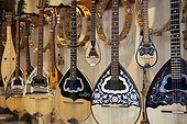 Bouzouki instruments for sale. a music shop with a row of stringed Bouzouki instruments for sale