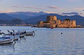 the fortress island of Bourtzi. traditional fishing boats moored in Nafplio harbour with the fortified island of Bourtzi at dawn