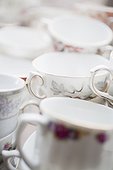 COLLECTION OF VINTAGE TEACUPS IN CAFE