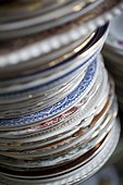 STACK OF OLD FASHIONED VINTAGE PLATES IN CAFE