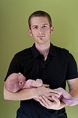 Man holding newborn baby