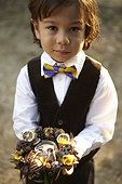 Young boy who is a ring bearer at a wedding wearing suit outside
