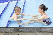 Kid learns swimming with his mother
