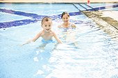 Mother and kid relaxed in swimming pool