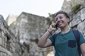 Teenage woman traveling through Central Europe while speaking on her mobile phone.