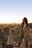 Beautiful woman taking in the ancient temple sights during sunset in Bagan, Myanmar.