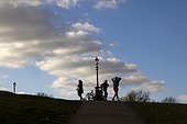 Silhouettes of people at the top of the hill, in northern Regent Park, London.UK.
