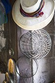 man's summer fedora, wire baskets and traps.