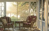 Screened in porch with wicker chairs and daisies, Hideaway Inn, Ohio