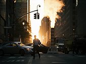 Sunset over midtown Manhattan street with steam in New York City.