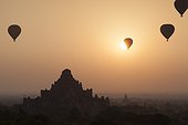 Dhammayangyi temple with hot air balloons at sunrise in Bagan, Myanmar.