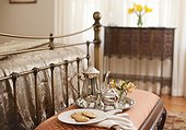 Silver set and cookies on bench at end of bed in bedroom, Mount Merino Manor, Hudson, New York