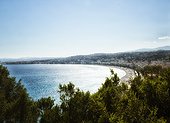 panoramic late afternoon view of old town Nice, French Riviera, with beach, promenade, and coast