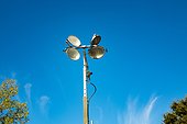Mast of a temporary, gasoline-powered lighting system, used to illuminate parking lots and construction sites, is visible against a bright blue sky, with clouds and treetops also visible, September 23, 2016. (Photo via Smith Collection/Getty Images) [...]