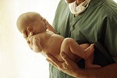Doctor holding newborn