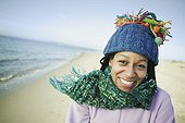 Woman in hat and scarf on beach