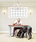 Man eating with his dog