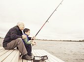 Grandfather fishing with grandson