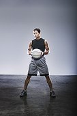 Young adult man holding basketball