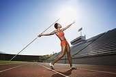 Athletic woman throwing a javelin