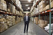 Smiling businessman in warehouse