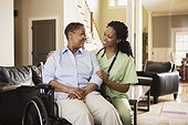Nurse with woman in wheelchair at home