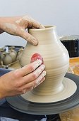 Ceramic artist working in her workshop with a potter's wheel, turning a vase, Geisenhausen, Bavaria, Germany, Europe